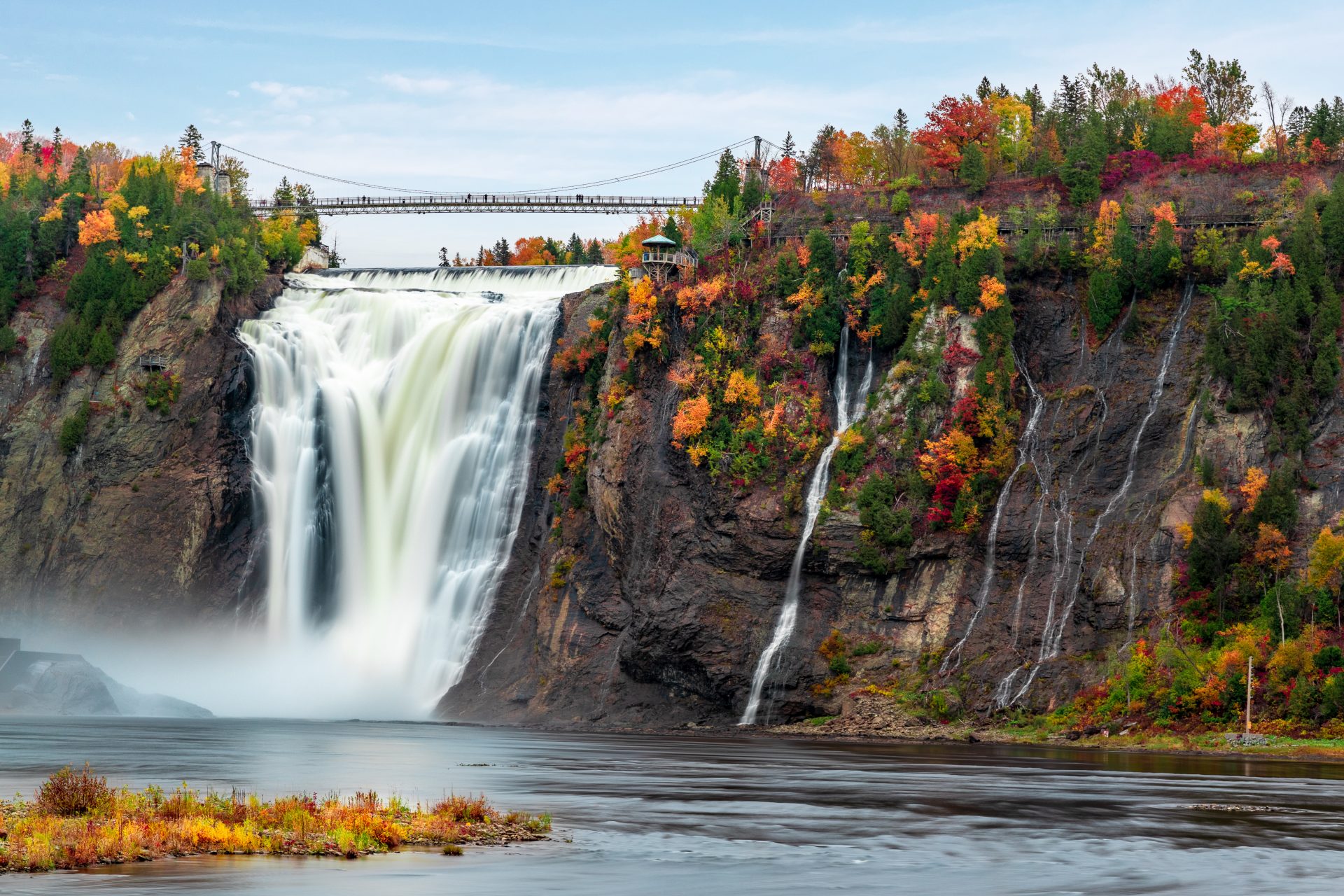 Montmorency Falls and Bridge in autumn with colorful trees